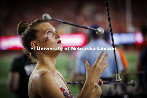 Britney Berry, one of two feature twirlers in the Cornhusker Marching Band, performs at the Nebraska