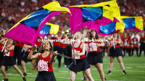 Cornhusker Marching Band Color Guard twirl their flags at the Nebraska vs. Illinois football game. S