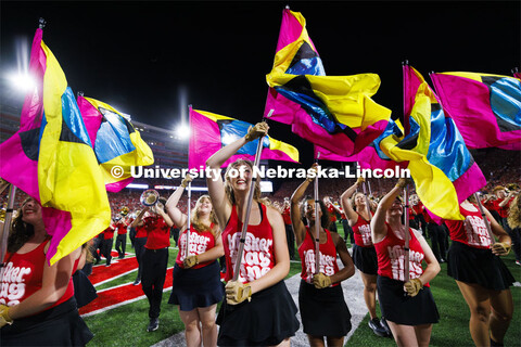 Cornhusker Marching Band Color Guard twirl their flags at the Nebraska vs. Illinois football game. S