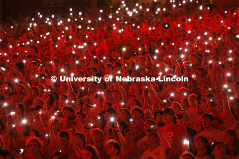 Fans illuminate a darkened stadium with their phone lights at the Nebraska vs. Illinois football gam