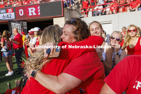 Homecoming royalty Emmerson Putnam receives a hug at the Nebraska vs Rutgers football game. Homecomi