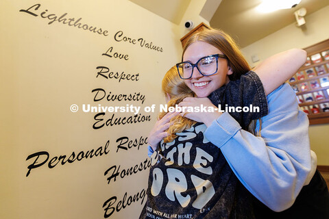 Alex Hughes, Lighthouse's volunteer and community outreach coordinator and UNL alumna, right, hugs E