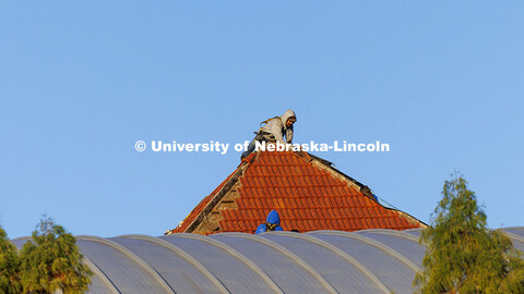 Workers remove the roofing tiles on the Temple Building. November 12, 2024. 