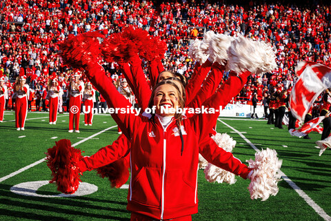 Danielle Blum, a junior graphic design major and Husker Cheerleader stands in front of the group of 