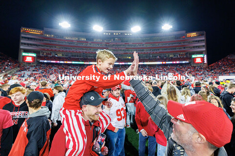 Husker fans storm the field following the team’s 44-25 win over Wisconsin to secure bowl game elig