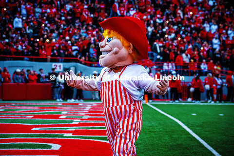 Herbie wearing red and white striped overalls works the crowd during the 4th quarter celebration at 