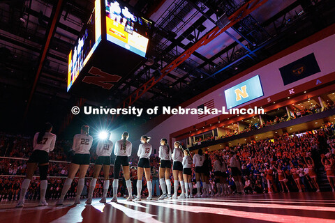 Light shines on the Husker volleyball team as they are being introduced during round one of the NCAA