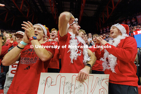 Bodie True (from left) Jacob Imig, and Andrew McNamara cheer on the Husker volleyball team during ro