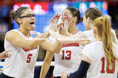 Nebraska’s Rebekah Allick (left) sticks her tongue out after scoring a point during round two of t