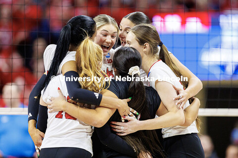 Members of the Nebraska volleyball team celebrate after scoring a point during round two of the NCAA