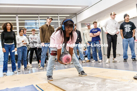 Oluwatofunmi Ejembi, junior, prepares to throw her team’s ball during the Concrete Bowling Competi