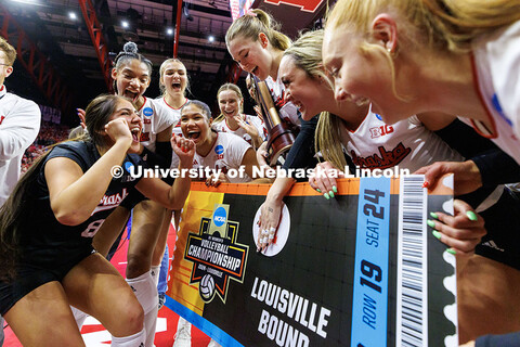 The Nebraska volleyball team celebrates by stamping their ticket to Louisville after beating Wiscons