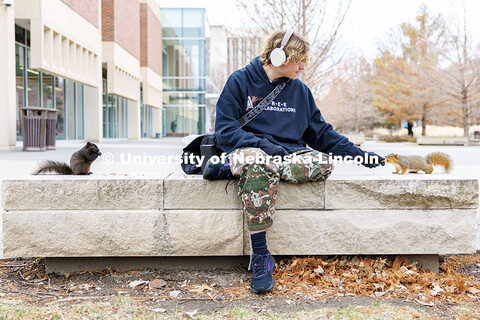 Dalton Dailey, junior, feeds squirrels outside of Love Library. December 17, 2024. 