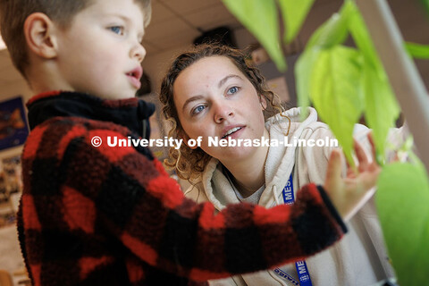 Vanessa Schechinger, senior Elementary Education and Early Child Education major, looks at plants wi