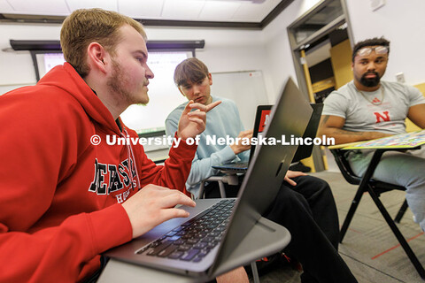 Dylan DuPont, left, senior Sports Media and Communication major, collects data from his group's game