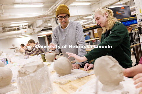 Santiago Cal, Professor of Art (Sculpture) in the School of Art, Art History and Design, helps Lewis