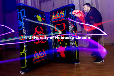 Mark Malmay aims at an opponent during a round of laser tag inside the Centennial Room of the Nebras