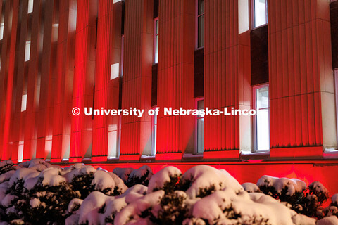 Love Library is lit up in red with gobos projected on the front saying, “Glow Big Red”. Glow Big