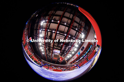 Fisheye view of Ayzhia Hall as she performs her beam routine during their gymnastics meet against Mi