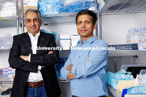 Amit Saini (left) and Alok Kumar, professors of marketing in the College of Business, stand in a med