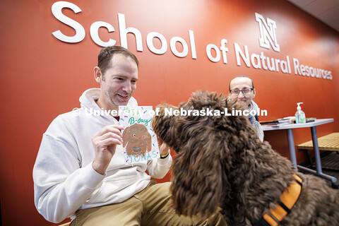 Kenneth Pyle, left, student success coach in the School of Natural Resources, shows his dog Jonas a 