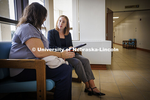 Law students meet with a mock client in the courthouse hallway in the Housing Justice Clinic. Colleg