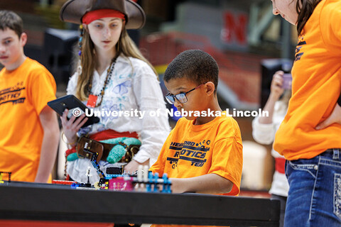 Members from the “Hemingford Robotics” group work on their robot during their practice round at 
