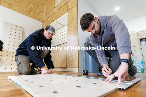 Third year architecture students Devyn Beekman, right, and Ethan Watermeier measure what they will c