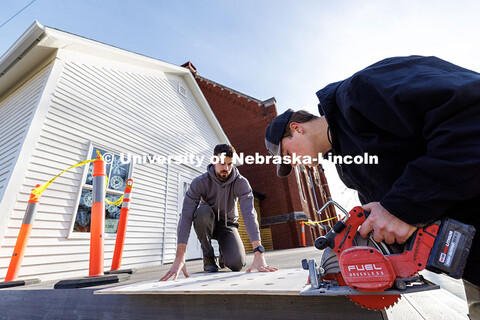 Third year architecture students Ethan Watermeier, right, and Devyn Beekman cut a section off of a p