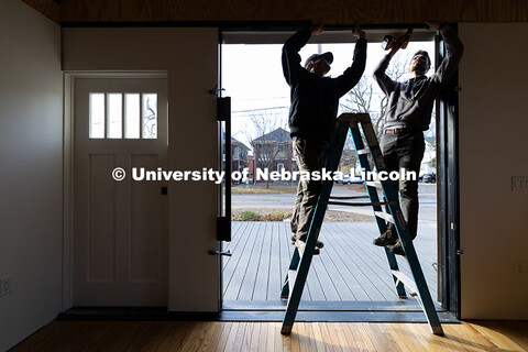 Third year architecture students Ethan Watermeier, left, and Devyn Beekman work together to place a 