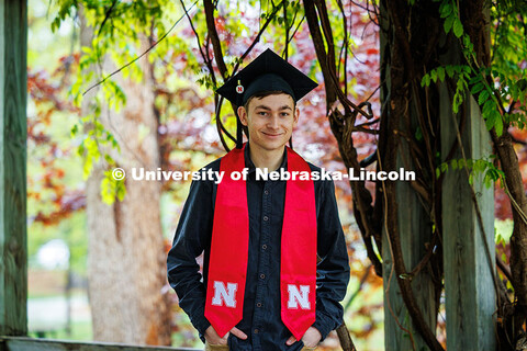 Caden Simon poses for a portrait under the vine arbor in the University of Nebraska–Lincoln's Maxw