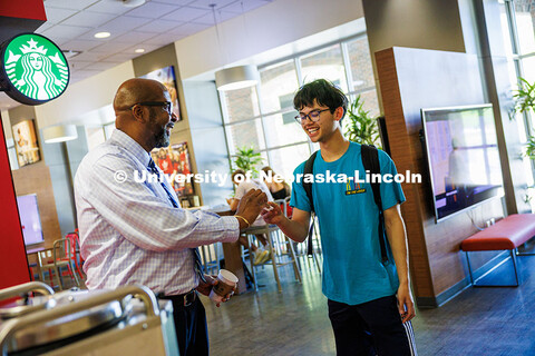 Chancellor Rodney D. Bennett laughs with Zachary Jacobsen (right), a junior Chemistry and Music majo