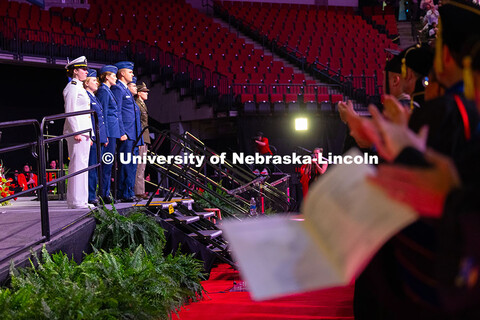 Students and faculty clap for ROTC students who gave their Oath of Office during the morning commenc