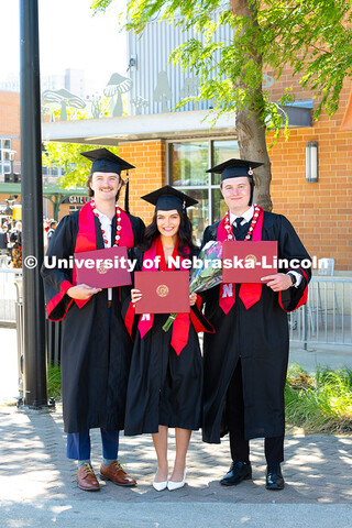 Triplets Josh, Paige and Drew Ferguson pose with their diplomas outside of Pinnacle Bank Arena after