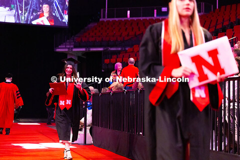 College of Arts and Sciences graduate, Jasmine Amaya, waves toward the camera after receiving her di