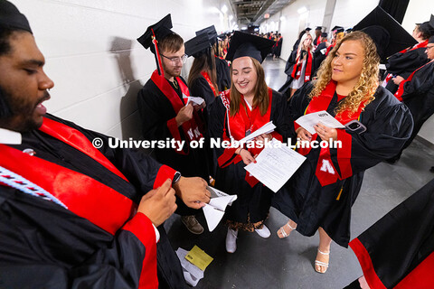 Agronomy major Charlotte Brockman holds a paper airplane made of her former economics homework. Broc