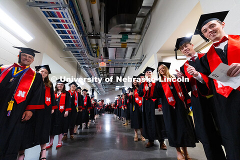 Graduates pose as they line up for the processional into Pinnacle Bank Arena for the University of N