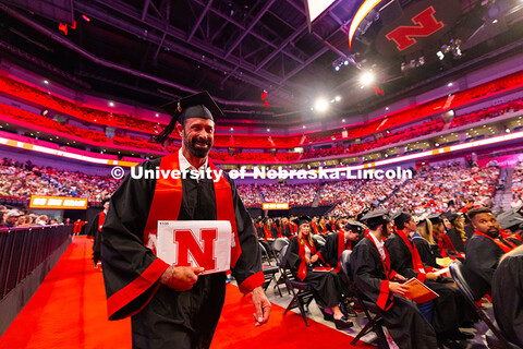 Travis Langemeier grins as he walks back to his seat with his diploma. Langemeier received his Bache