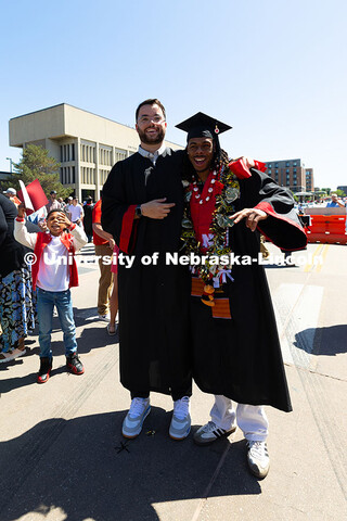 College of Business grads Jarrett Michie and Je'Cory Harris pose outside of Pinnacle Bank Arena afte