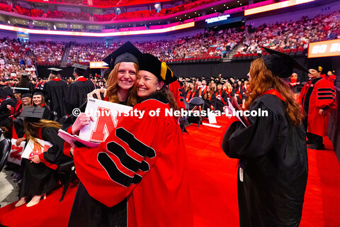 Dr. Kim Hansen hugs Alyssa Vetere, who served as a teaching assistant in Hansen's human physiology c