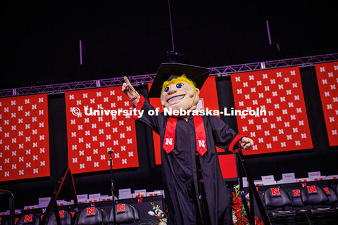 Herbie points into the air to celebrate the May 2025 Commencement Undergraduate Commencement in Pinn