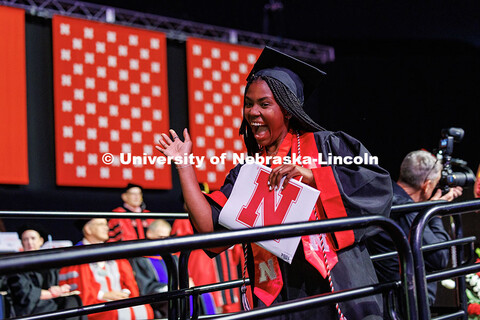 Teish Ngoi, a Theatre Arts major, waves after she receives her diploma. May 2025 Commencement Underg