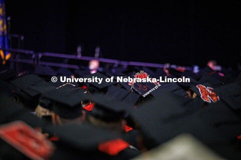 In a sea of mortarboards one decorated grad cap reads “The Rest is Still Unwritten”. May 2025 Co