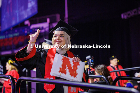 Child, Youth and Family Studies and English major, Sarah Al-Tewaig, waves at family after receiving 
