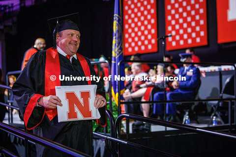 Corrie Svehla, the Assistant Director of Special Events for UNL walks down the stage after receiving