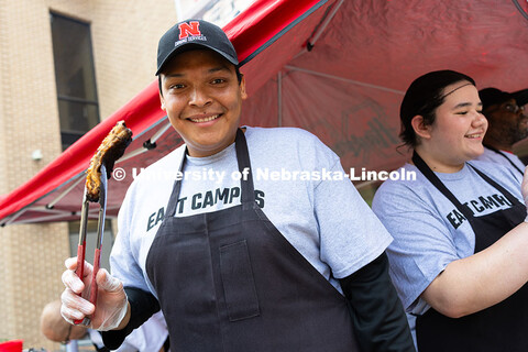 Franklin Yankton, a member of the East Campus Dining Services team, proudly holds up one of the pork