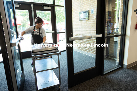 Marilou Wyatt, East Campus Dining Services production manager, takes a cart loaded with smoked chick