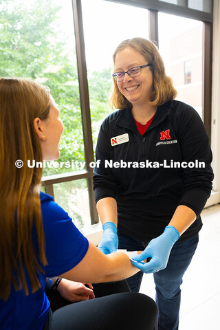 Jen Krueger, Senior Coordinator for Injury Prevention and Care, smiles at Kelci Davis, one of her st