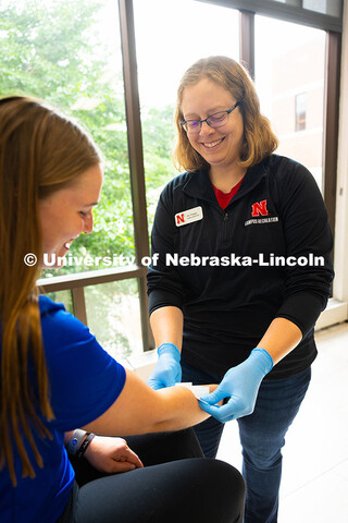 Jen Krueger, Senior Coordinator for Injury Prevention and Care, smiles at Kelci Davis, one of her st