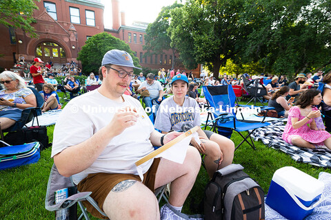 Britt Coudriet (right) sits next to Sam Voelker, who brought a cross-stitch project to work on while